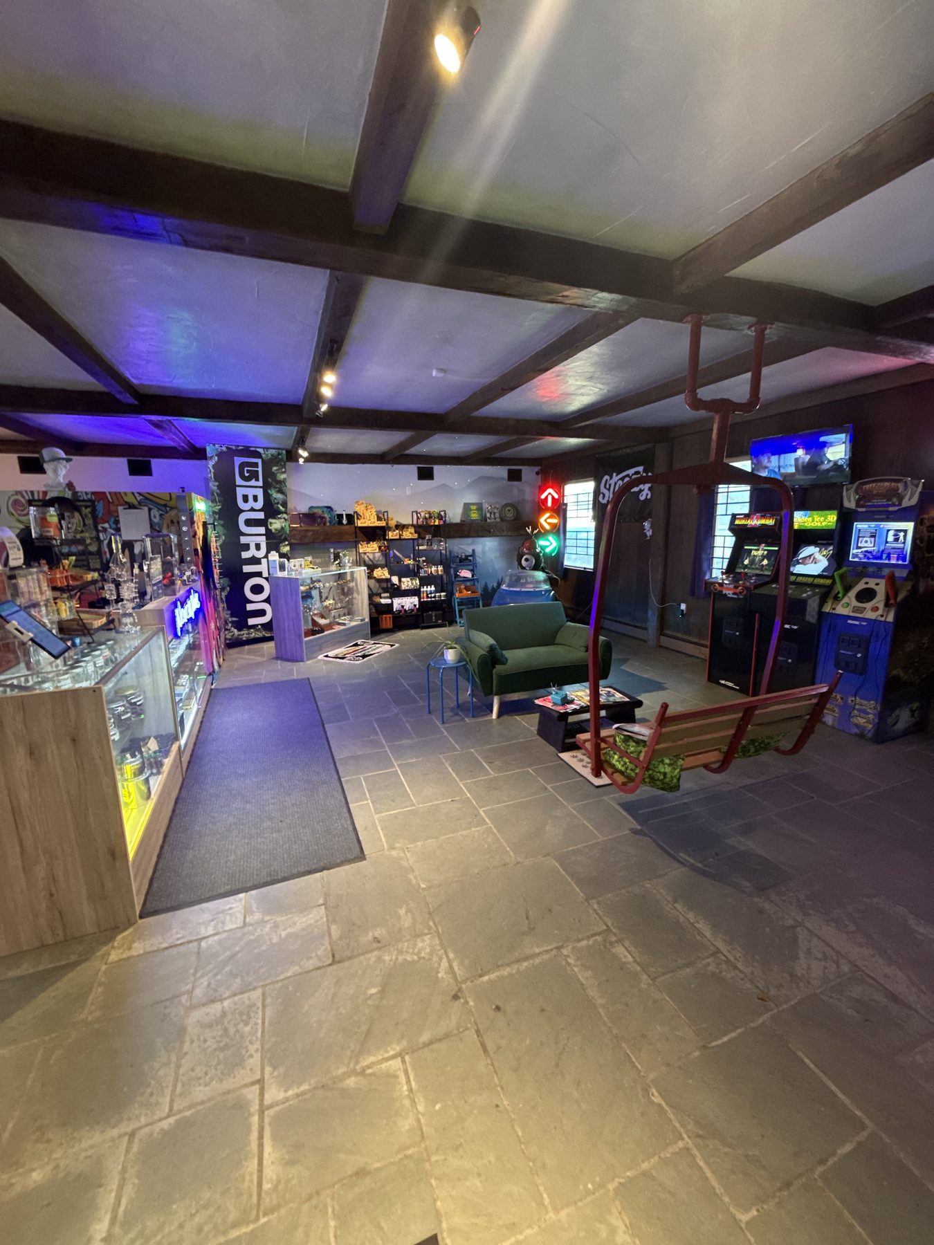Inside Notch Nugs: the counter, lounge, ski-lift seat, and arcade